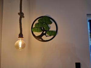 a round mirror hanging on a wall next to a light at Zatoka Wypoczynku Apartamenty in Władysławowo