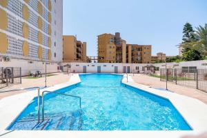 a swimming pool in the middle of a city at Elegante Apartamento cerca al mar in Roquetas de Mar