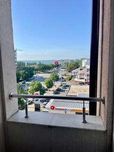 a window with a view of a parking lot at The View Apartment in Constanţa