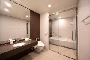 a bathroom with a sink and a toilet and a shower at Holiday Inn Osaka Namba by IHG in Osaka +26 photos