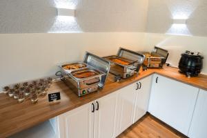 a kitchen counter with trays of food on it at besttime Hotel Boppard in Boppard