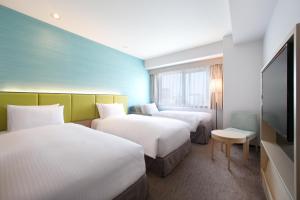 Ein Bett oder Betten in einem Zimmer der Unterkunft Holiday Inn Osaka Namba by IHG