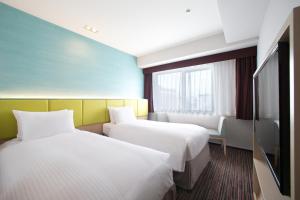 Ein Bett oder Betten in einem Zimmer der Unterkunft Holiday Inn Osaka Namba by IHG