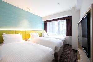 Ein Bett oder Betten in einem Zimmer der Unterkunft Holiday Inn Osaka Namba by IHG