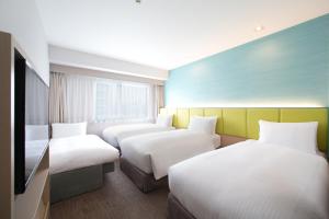 Ein Bett oder Betten in einem Zimmer der Unterkunft Holiday Inn Osaka Namba by IHG