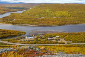 an aerial view of a river and a village at Utsjoki Arctic Resort in Utsjoki
