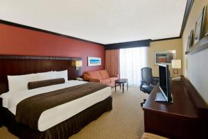 a hotel room with a large bed and a desk at Crowne Plaza Albuquerque by IHG in Albuquerque