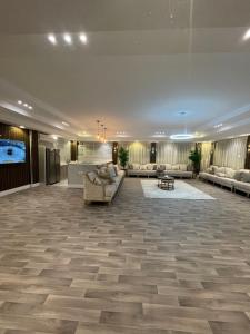 a large lobby with couches and a flat screen tv at القمة العالية in Abha