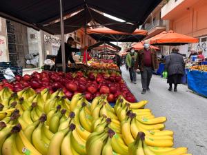 a market with bananas and other fruits on display at Stylish & relaxing 70 sq. m. flat with balcony in Athens