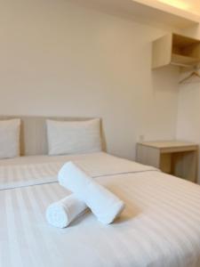 a roll of toilet paper sitting on a bed at Vvip Hotel in Hutan Melintang