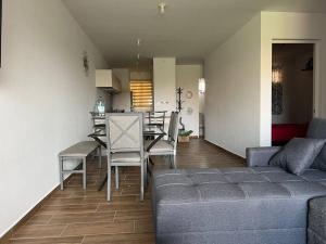 a living room with a couch and a table and chairs at Ancla203 in Altata
