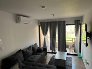 a living room with a couch and a large window at Ancla203 in Altata