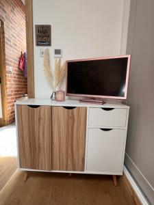 a white entertainment center with a flat screen tv on it at New Converted Barn in Hereford