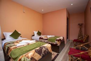 a hotel room with two beds and a window at Bandipur Eco Hotel in Bandīpur
