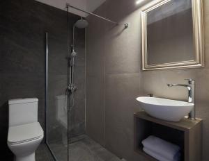 a bathroom with a toilet and a sink and a shower at Charm Hotel, Hersonissos in Hersonissos