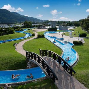 a bridge over a water park with people in water slides at Family apartment 'Sofia' in Brežice