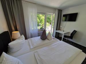 Postel nebo postele na pokoji v ubytování Apart Hotel Freiburg