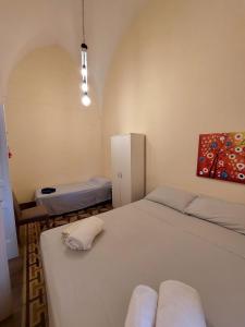 a bedroom with two twin beds and a cabinet at Casa Paola in Cutrofiano