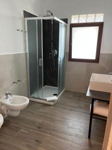 a bathroom with a shower and a toilet and a sink at Turismo Rurale Lu Stazzu Arzachena in Arzachena