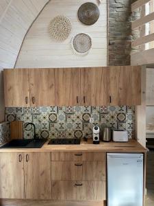 a kitchen with wooden cabinets and a counter top at GRASÓWKA in Werlas