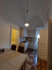 a kitchen with a table and chairs in a room at Casa Paola in Cutrofiano