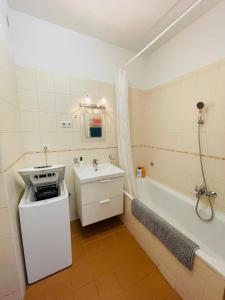 a bathroom with a sink and a bath tub at Broadway Apartments in Budapest