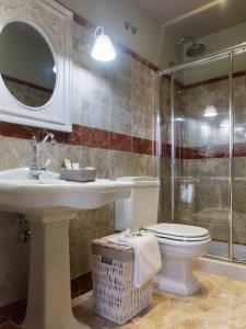 a bathroom with a toilet and a sink and a shower at Hotel Real Cambados in Cambados