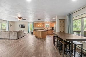 a kitchen and living room with a table and a couch at Hot Tub! LRG Home! Sleeps 24!Near Ithaca! Dogs OK in Lansing