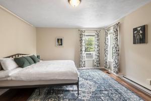 a bedroom with a bed and a window at Hot Tub! LRG Home! Sleeps 24!Near Ithaca! Dogs OK in Lansing