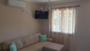 A television and/or entertainment centre at Xristina's Experience
