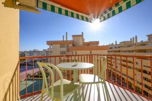 a balcony with a table and chairs on a balcony at Burgos 2 Terrace, pool, parking by 10ToSea in Fuengirola