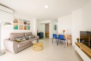 a living room with a couch and a table at Burgos 2 Terrace, pool, parking by 10ToSea in Fuengirola