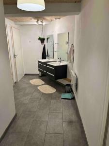 a bathroom with a sink and a mirror at Marielyst, idyllisk feriehus 800m fra torvet in Marielyst