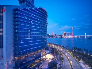 widok na budynek w nocy z miastem w obiekcie Sheraton Zhuhai Hotel w mieście Zhuhai