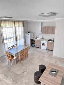 a kitchen with a table and chairs in a room at Rio cottage apartment in Ureki