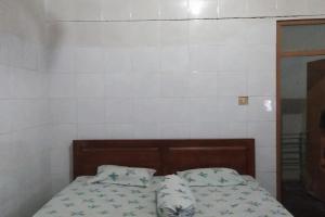 Postel nebo postele na pokoji v ubytování Hotel Merak Indah