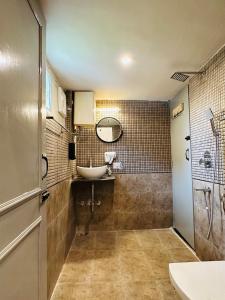 a bathroom with a sink and a mirror at AnandMai Ghar - A Homestay in Gwalior in Gwalior