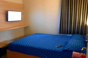 Postel nebo postele na pokoji v ubytování Hotel Merak Indah