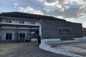 een gebouw met een bord aan de zijkant bij Hotel Merak Indah in Klaten