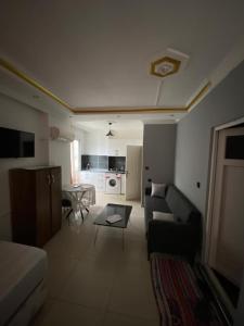 a living room with a couch and a table at REKOR OTEl in Antalya