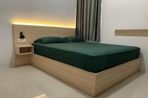 Postel nebo postele na pokoji v ubytování Hotel Merak Indah