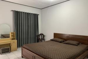 Postel nebo postele na pokoji v ubytování Hotel Merak Indah