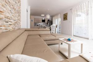 a living room with a couch and a table at Holiday Home Ninna in Crikvenica