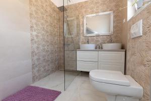 a bathroom with a toilet and a sink and a mirror at Holiday Home Ninna in Crikvenica