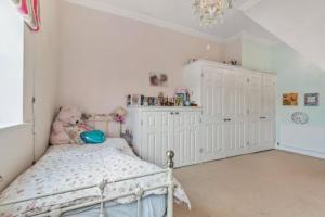 a bedroom with a bed with a teddy bear in it at A Hidden Gem in Burnham