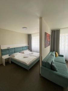 a bedroom with a large bed and a couch at Jantar Resort in Szczecin +113 photos