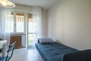 een woonkamer met een blauwe bank voor een raam bij Interno 2 in Iseo +25 foto's