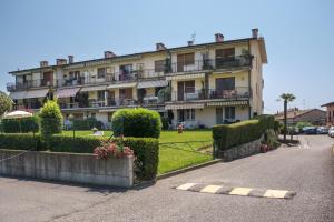 a large building with bushes and flowers in front of it at Interno 2 in Iseo