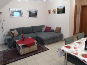 a living room with a couch and a table at LANDHAUS JASMIN ausgezeichnet mit 4 Kristallen - FW Zinkenblick in Bad Mitterndorf