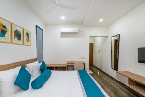 a bedroom with a bed and a tv at SKYLA Serviced Apartments & Suites, Hi-Tech City in Hyderabad